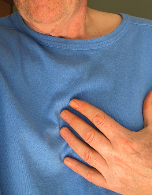 man touches his chest for signs of heart attack